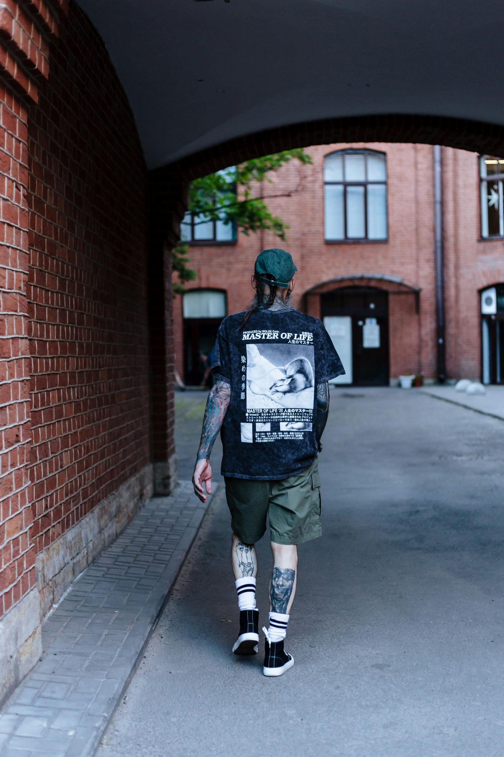 Man with Tattoos Walking through the Archway